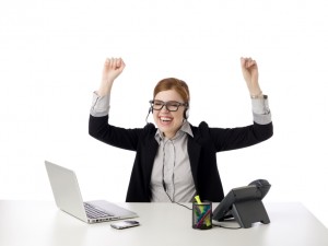 A happy female call center agent raising her hands against the white background
